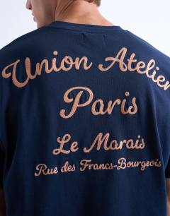 Model wearing Oversized Union Atelier embroidered t-shirt in navy