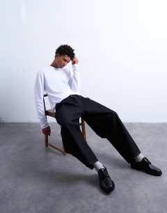 Model wearing Pleated barrel jean in raw black