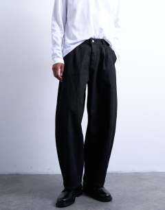 Model wearing Pleated barrel jean in raw black