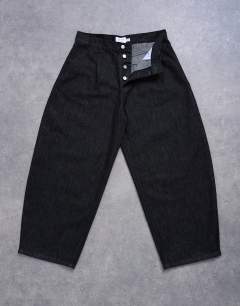 Model wearing Pleated barrel jean in raw black