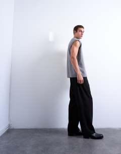 Model wearing Pleated wide leg trouser in black pinstripe