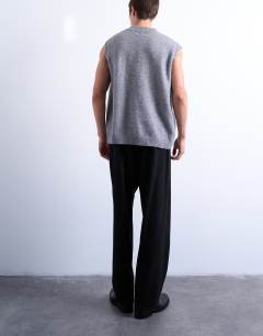 Model wearing Pleated wide leg trouser in black pinstripe