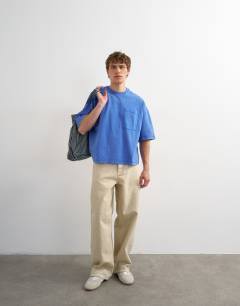Model wearing Premium boxy fit t-shirt with pocket in washed blue