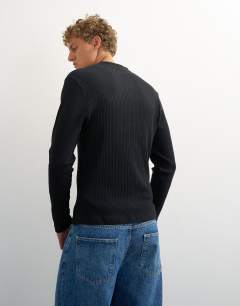 Model wearing Premium classic fit long sleeve textured henley in black