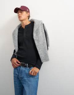 Model wearing Premium classic fit long sleeve textured henley with woven placket in black