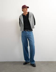 Model wearing Premium classic fit long sleeve textured henley with woven placket in black