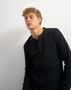 Model wearing Premium classic fit long sleeve textured henley with woven placket in black
