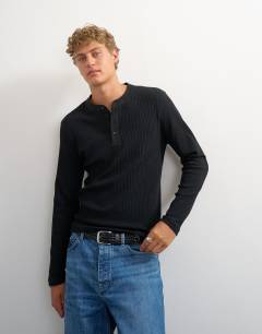 Model wearing Premium classic fit long sleeve textured henley with woven placket in black