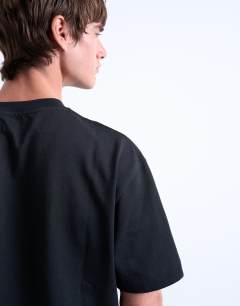 Model wearing Premium heavyweight crop t-shirt in black