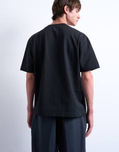 Model wearing Premium heavyweight crop t-shirt in black