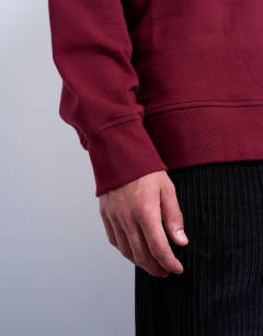 Model wearing Premium lightweight oversized fit sweatshirt in burgundy
