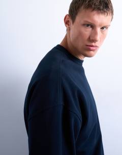 Model wearing Premium lightweight oversized fit sweatshirt in navy