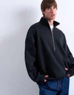 Model wearing Premium oversized fit  1/4 zip funnel neck in black