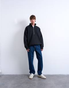 Model wearing Premium oversized fit  1/4 zip funnel neck in black