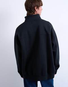 Model wearing Premium oversized fit  1/4 zip funnel neck in black