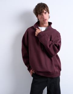 Model wearing Premium oversized fit 1/4 zip funnel neck in burgundy
