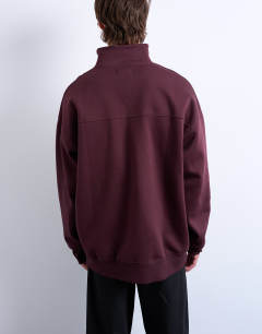 Model wearing Premium oversized fit 1/4 zip funnel neck in burgundy