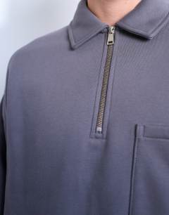 Model wearing Premium oversized fit 1/4 zip polo in grey