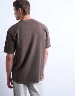 Model wearing Premium oversized fit t-shirt with nowhere embroidery in washed brown