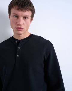 Model wearing Premium relaxed fit heavyweight waffle henley in black