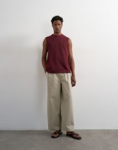 Model wearing Premium relaxed fit sleeveless t-shirt in dark burgundy
