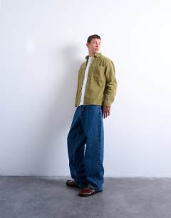 Model wearing Regular fit cord shirt in washed green