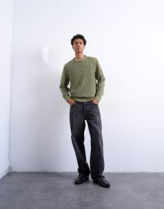 Model wearing Regular fit knitted jumper in washed green