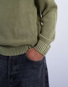 Model wearing Regular fit knitted jumper in washed green