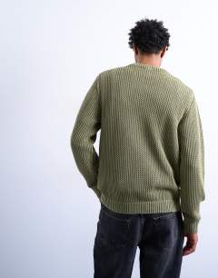 Model wearing Regular fit knitted jumper in washed green