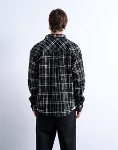Model wearing Regular fit textured check overshirt in black
