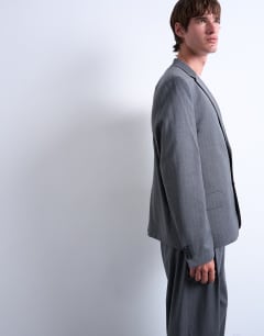 Model wearing Relaxed boxy blazer in charcoal pinstripe