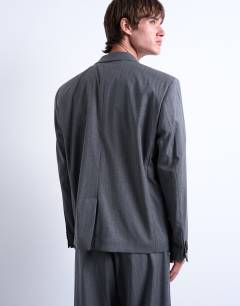 Model wearing Relaxed boxy blazer in charcoal pinstripe