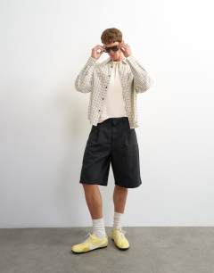 Model wearing Relaxed crop fit check shirt in ecru