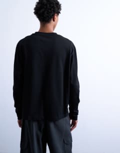 Model wearing Relaxed cropped fit long sleeve t-shirt in black