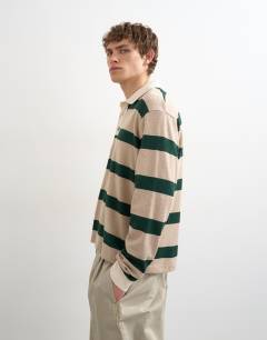 Model wearing Relaxed cropped wool mix long sleeve rugby polo in stone and green