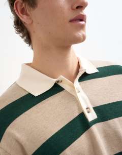 Model wearing Relaxed cropped wool mix long sleeve rugby polo in stone and green