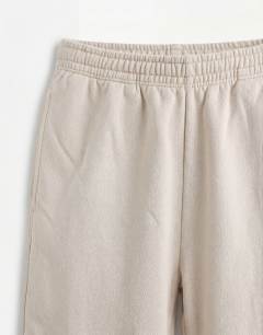 Model wearing Relaxed fit bermuda jogger short in washed stone