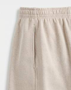 Model wearing Relaxed fit bermuda jogger short in washed stone
