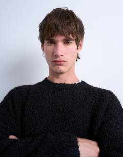 Model wearing Relaxed fit boucle jumper in black