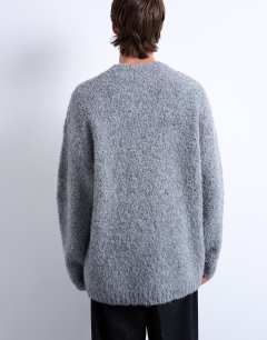 Model wearing Relaxed fit boucle jumper in light grey