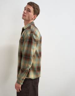 Model wearing Relaxed fit brushed cotton check overshirt in brown and yellow