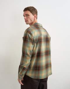 Model wearing Relaxed fit brushed cotton check overshirt in brown and yellow