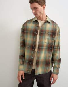 Model wearing Relaxed fit brushed cotton check overshirt in brown and yellow
