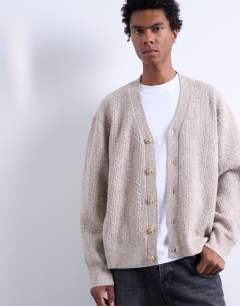 Model wearing Relaxed fit cable knitted cardigan in stone