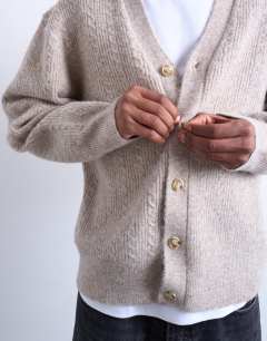 Model wearing Relaxed fit cable knitted cardigan in stone