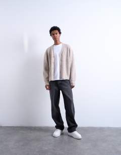 Model wearing Relaxed fit cable knitted cardigan in stone