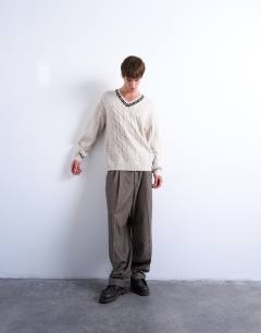 Model wearing Relaxed fit cable knitted v-neck jumper with fairisle trim in ecru