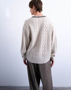 Model wearing Relaxed fit cable knitted v-neck jumper with fairisle trim in ecru