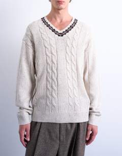 Model wearing Relaxed fit cable knitted v-neck jumper with fairisle trim in ecru