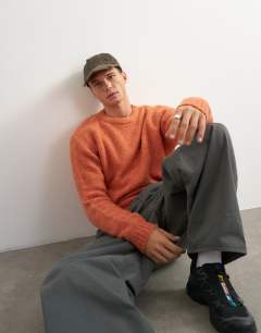 Model wearing Relaxed fit crewneck knitted jumper in orange